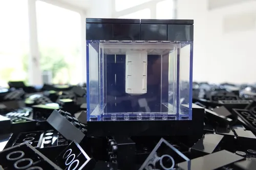 Quantego System One on a pile of black LEGO bricks